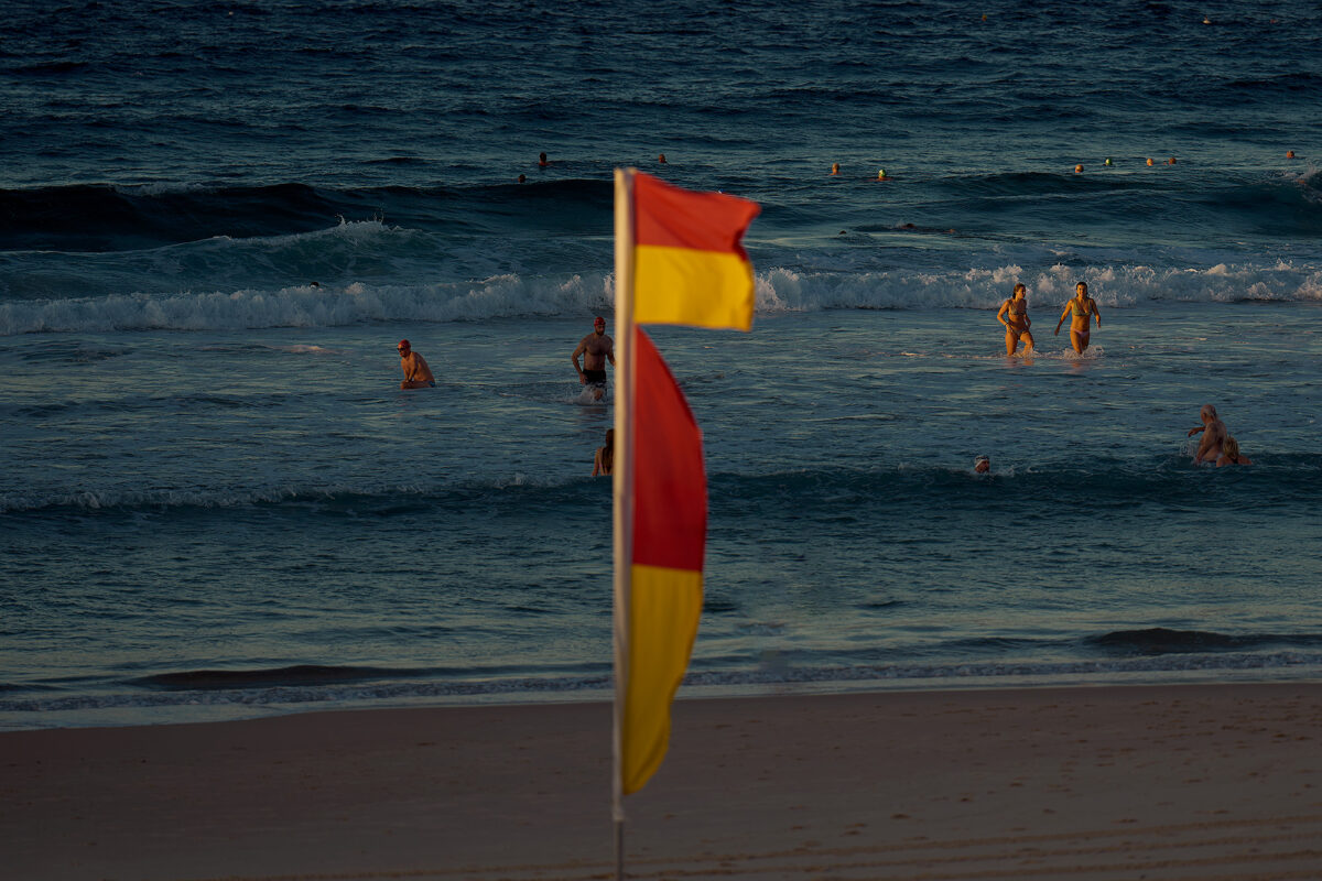 Autumn light, dripping into the beach, in between buildings. Bondi