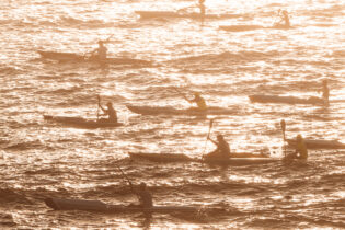 Morning traffic, sprayed in golden light. Bondi 7am