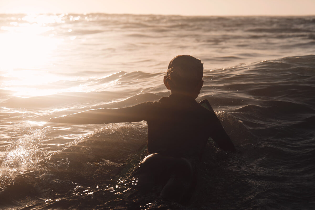 Little man paddling out